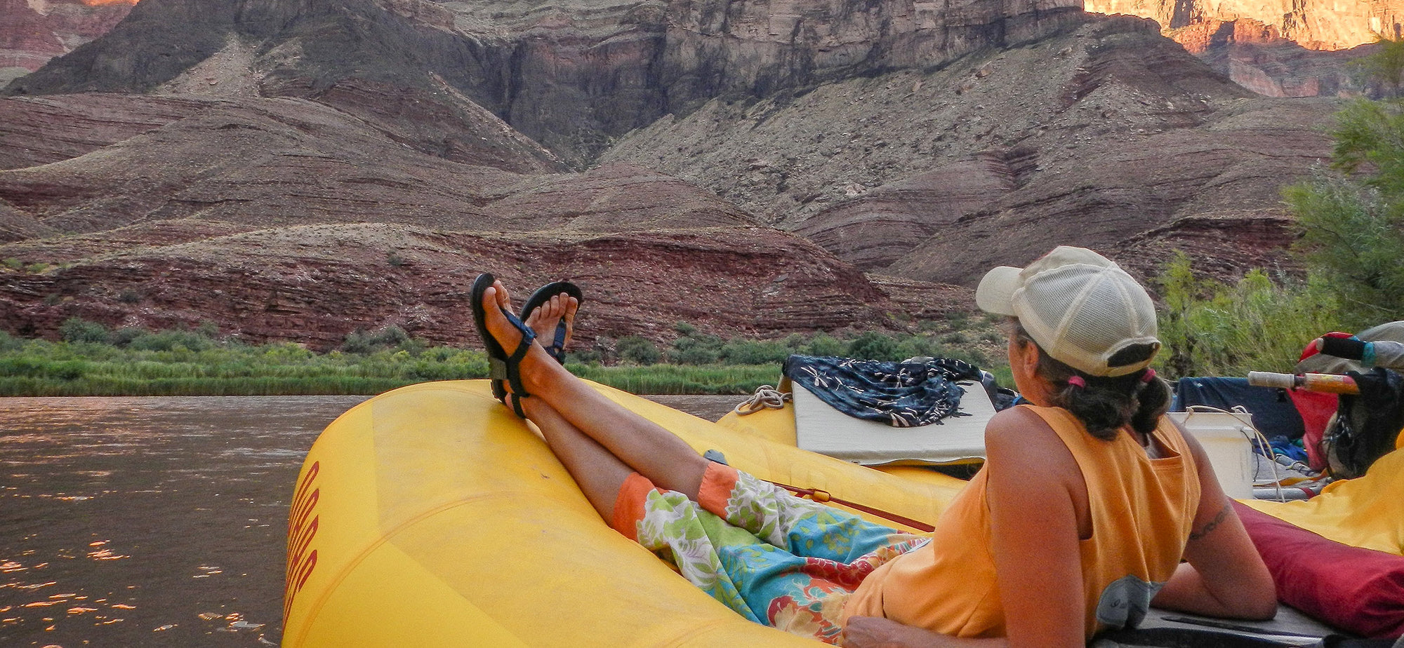 Grand Canyon Guide wearing trusty adventure sandals relaxing on a whitewater raft