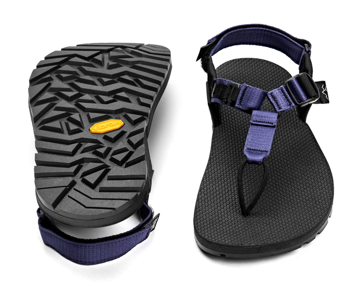 A pair of Cairn Evo Sandals with lupine purple straps and rugged Vibram XS Trek Evo sole.
