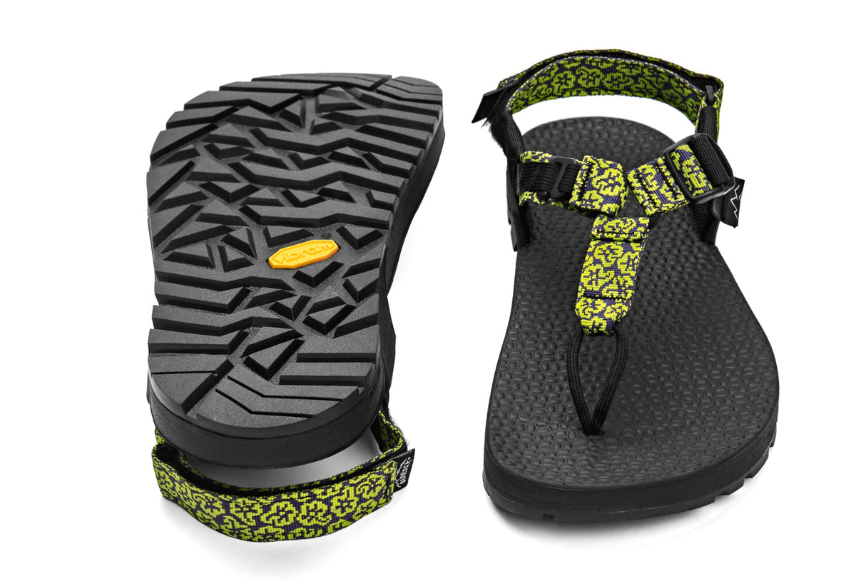 A pair of Cairn Evo 3D sandals with yellow wildflower patterned straps and a rugged black vibram Evo XS Trek sole.