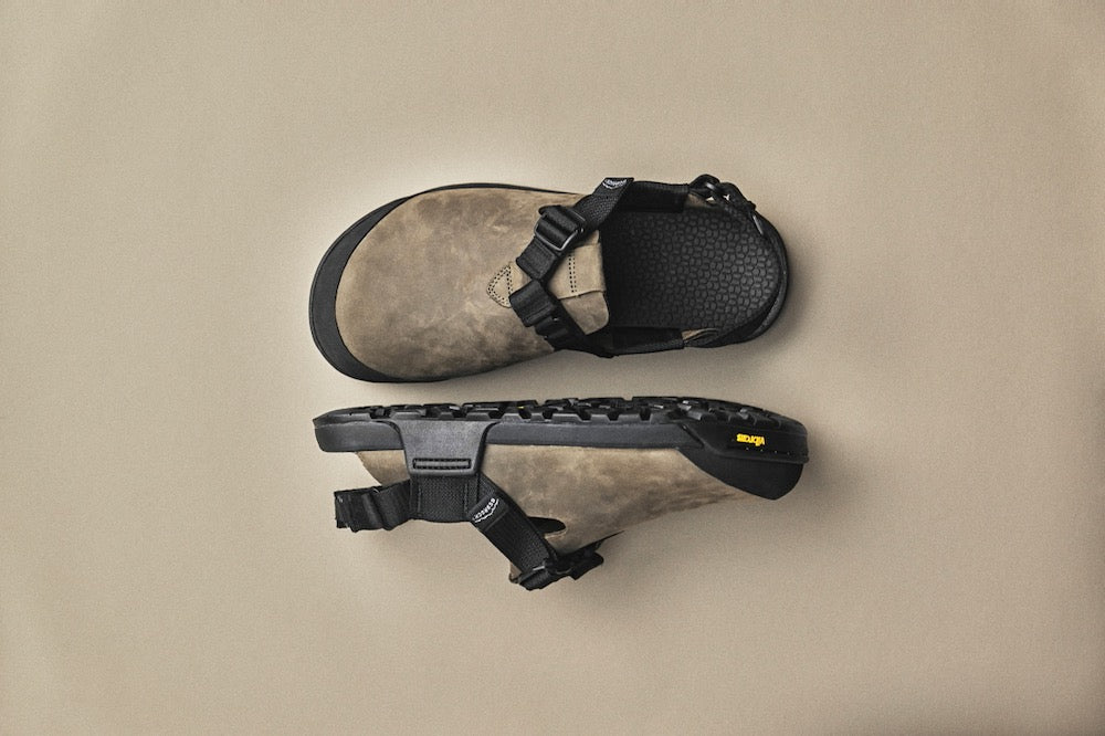 pair of gray nubuck leather clogs with gray studio background