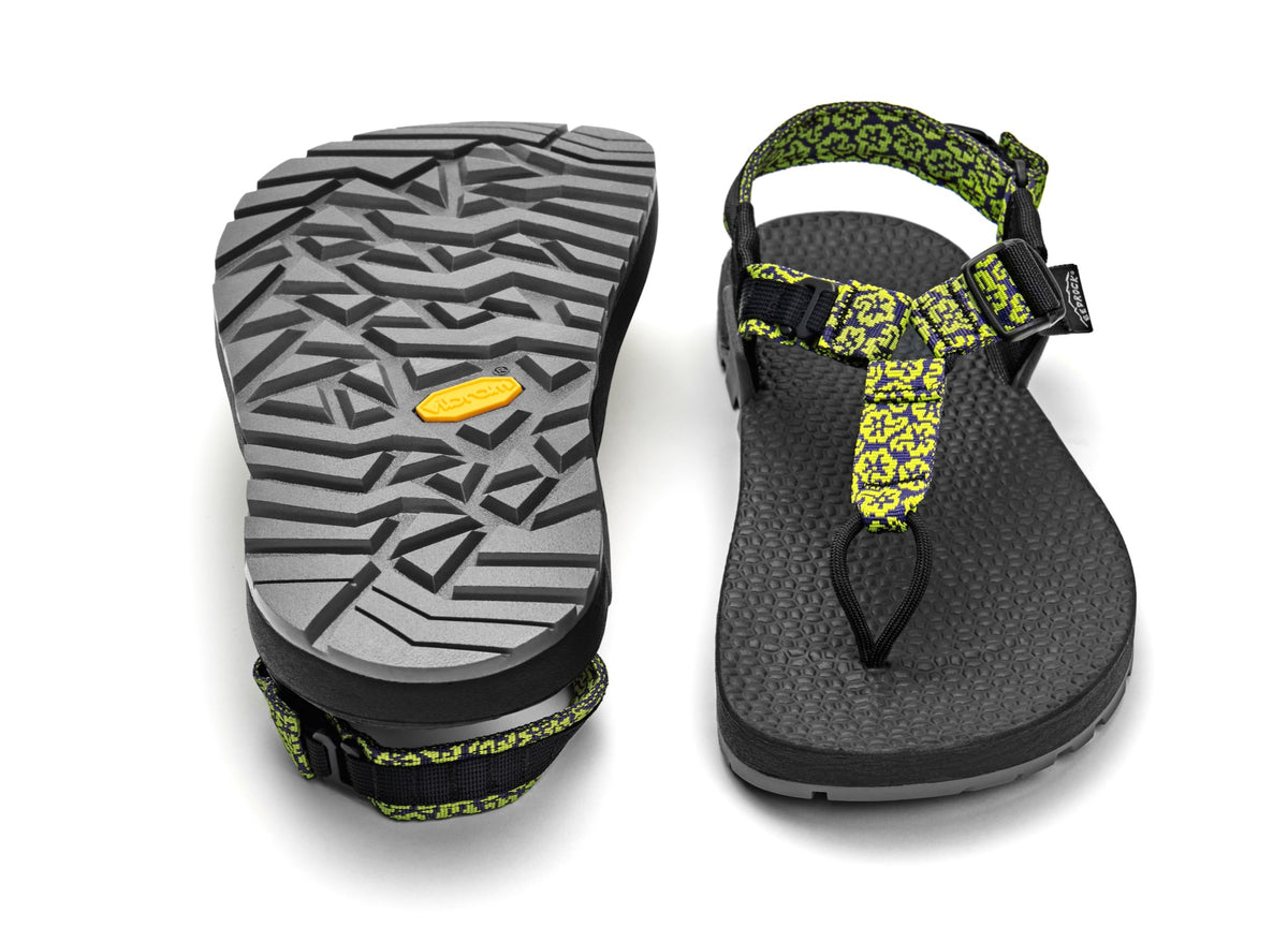 A pair of Cairn Evo 3D PRO sandals with yellow wildflower straps, featuring a gray rugged Megagrip vibram sole.