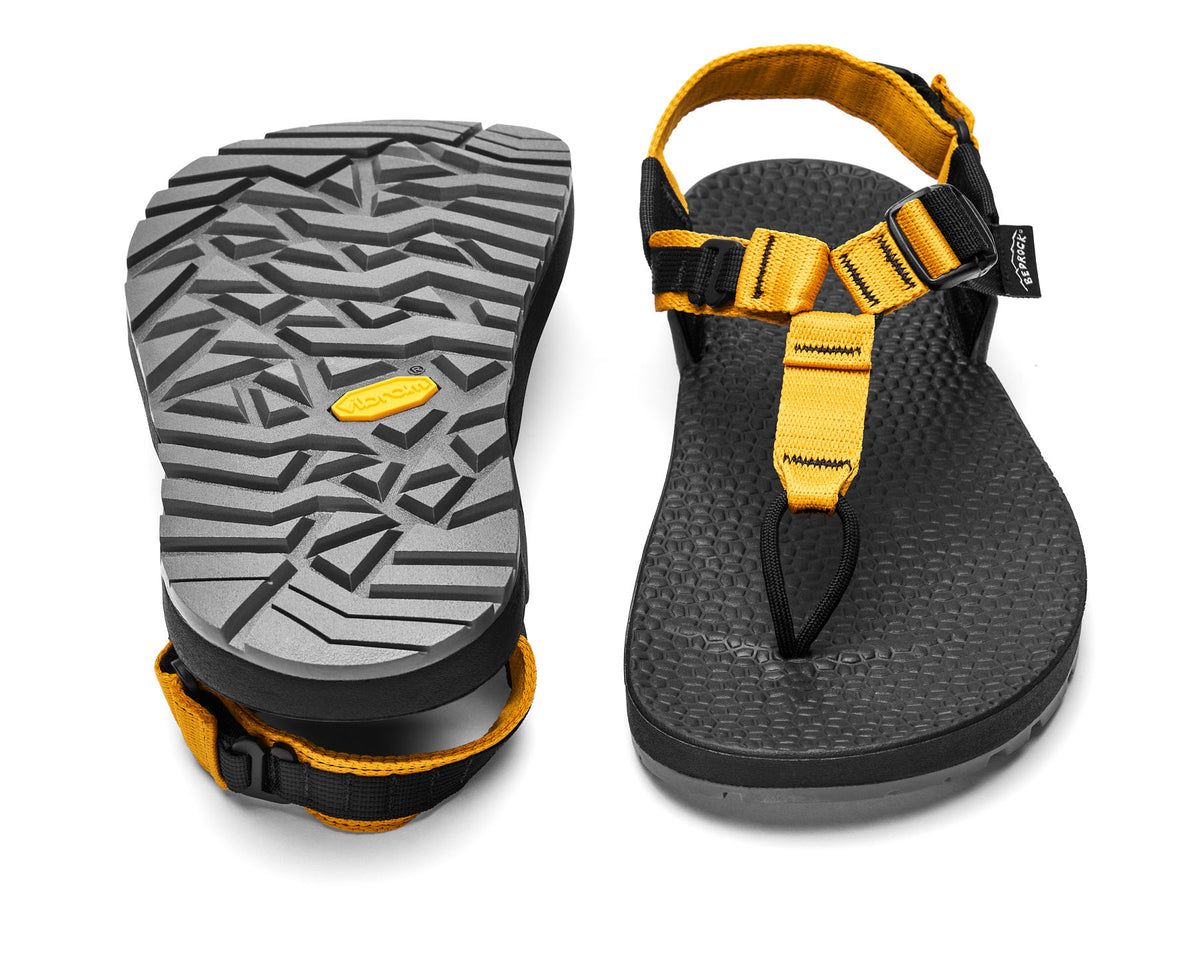 A pair of Cairn Evo 3D PRO sandals with yellow ochre straps, featuring a gray rugged Megagrip vibram sole.