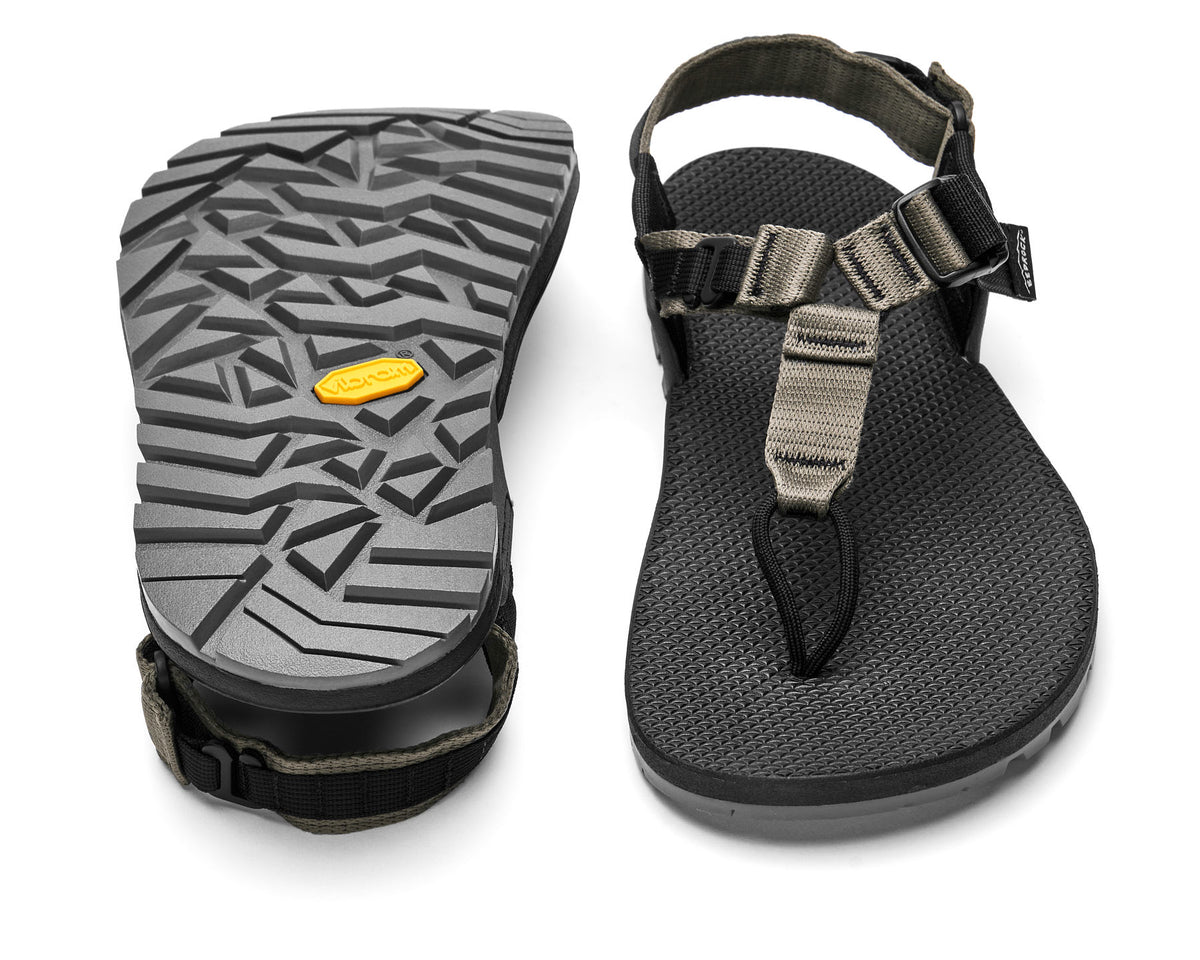 A pair of Cairn Evo PRO Sandals with charcoal straps and black footbed, featuring a hook-and-loop strap design and Vibram Megarip outsole.