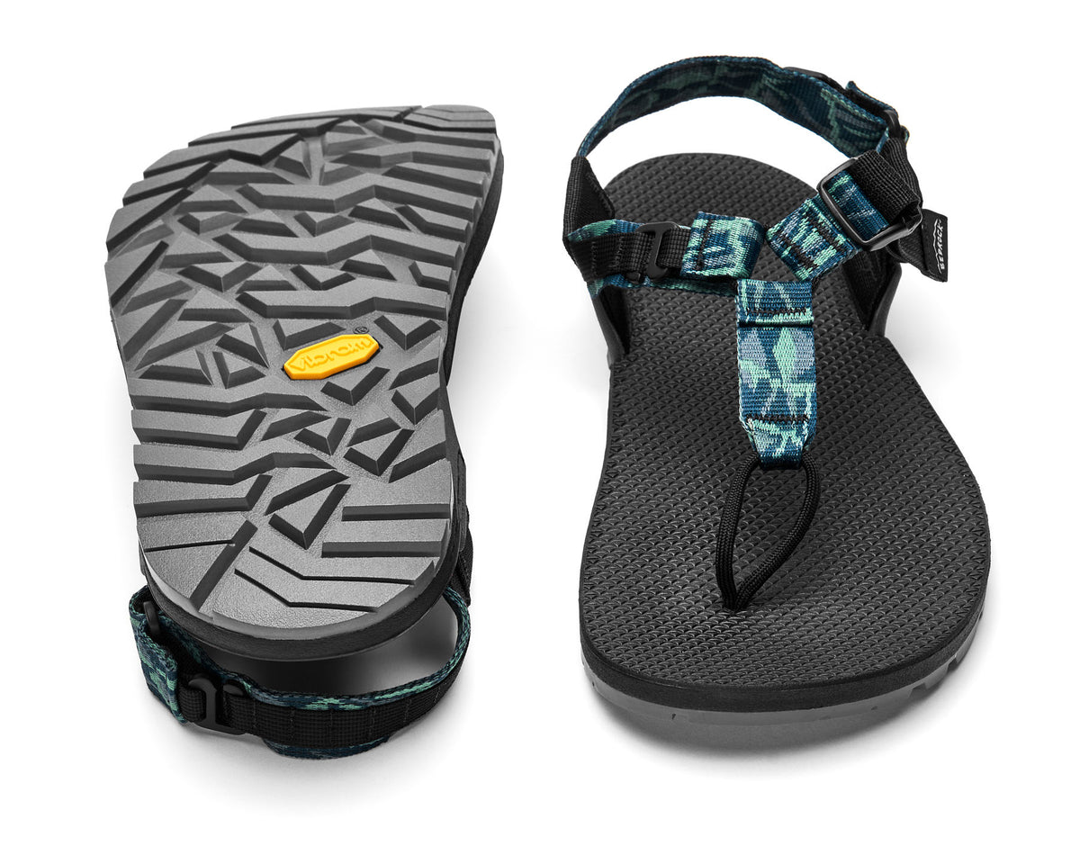 A pair of Cairn Evo PRO Sandals with blue patterned straps and black footbed, featuring a hook-and-loop strap design and Vibram Megarip outsole.