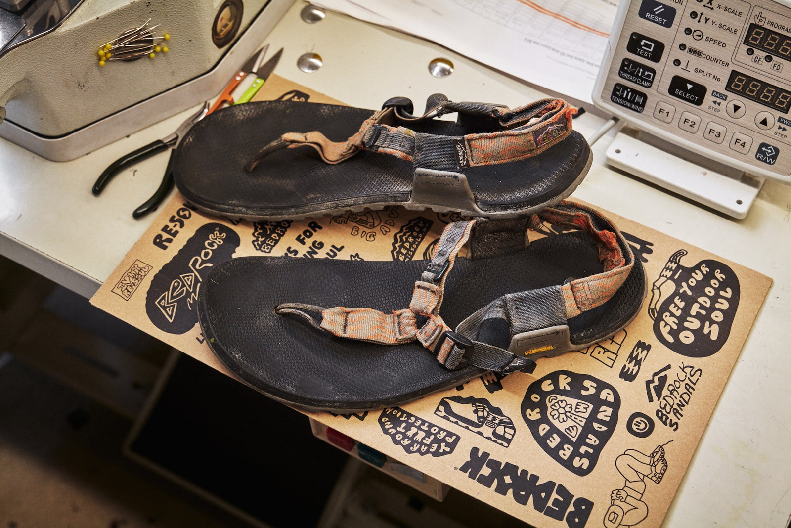 Worn pair of Cairn sandals on sewing table getting ready for Re-Soul.