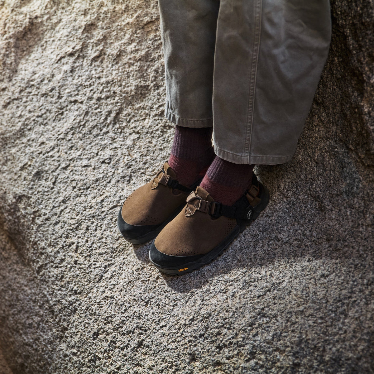 white granite rock backdrop with someone wearing synthetic mountain clogs