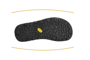 A black textured shoe sole with a small yellow Vibram logo, shown against a white background with two curved gold guide lines above and below.