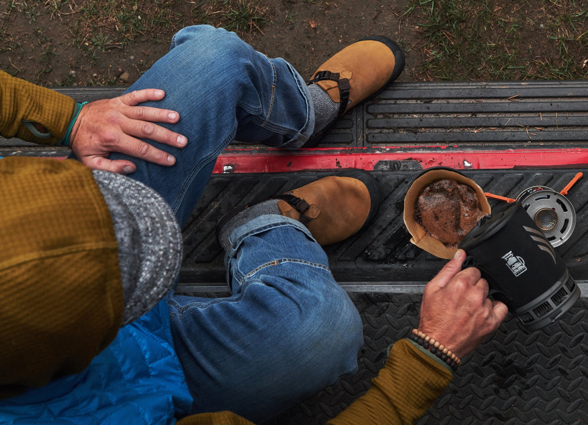 Person pouring coffee while wearing a pair of Brown Nubuck Leather Mountain Clog