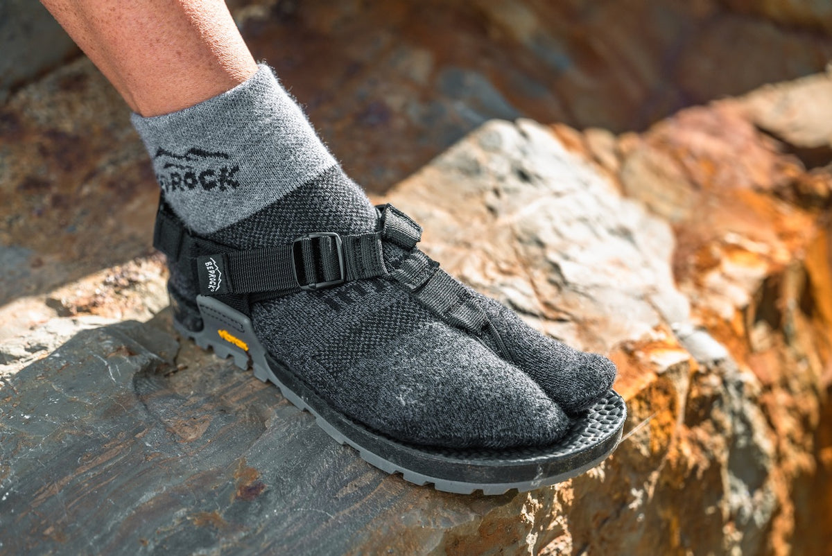 Person wearing Bedrock Injinji Split-Toe Performance Socks Granite on a rock