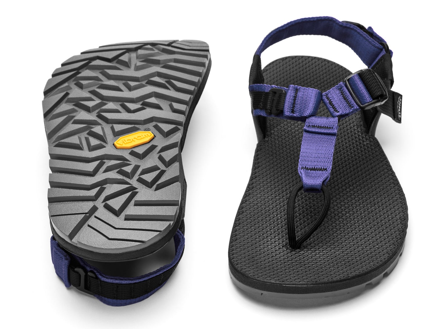 A pair of Cairn Evo PRO Sandals with lupine purple straps and black footbed, featuring a hook-and-loop strap design and Vibram Megarip outsole.