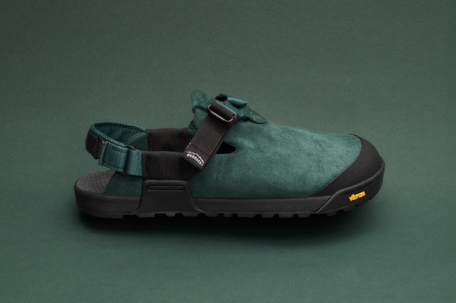 Mountain Clogs in Cascade Green Leather Suede set on a green backdrop