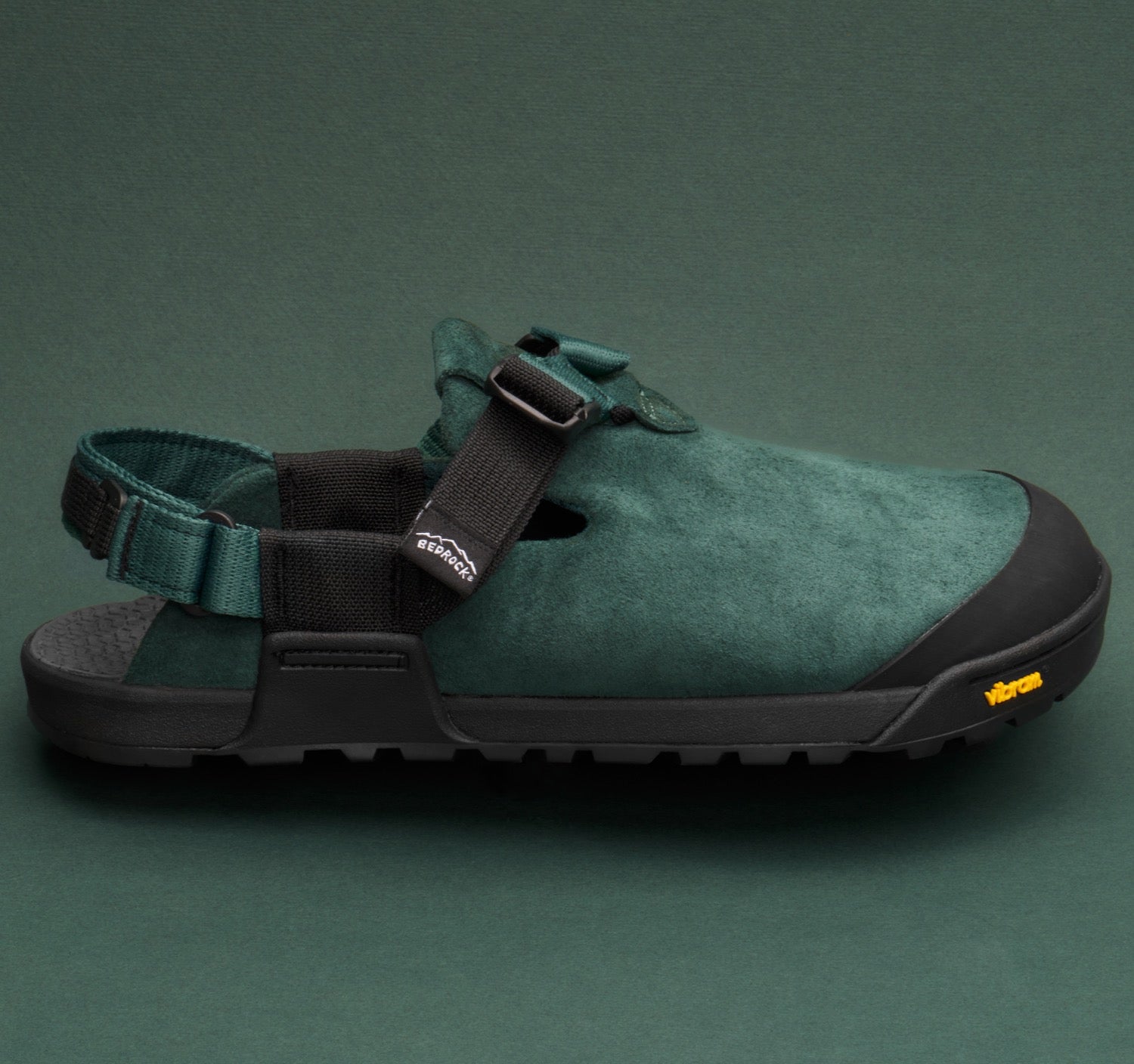 Mountain Clogs in Cascade Green Leather Suede set on a green backdrop