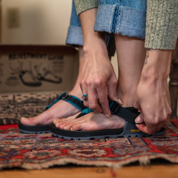 Person adjusting their Bedrock Sandals at home