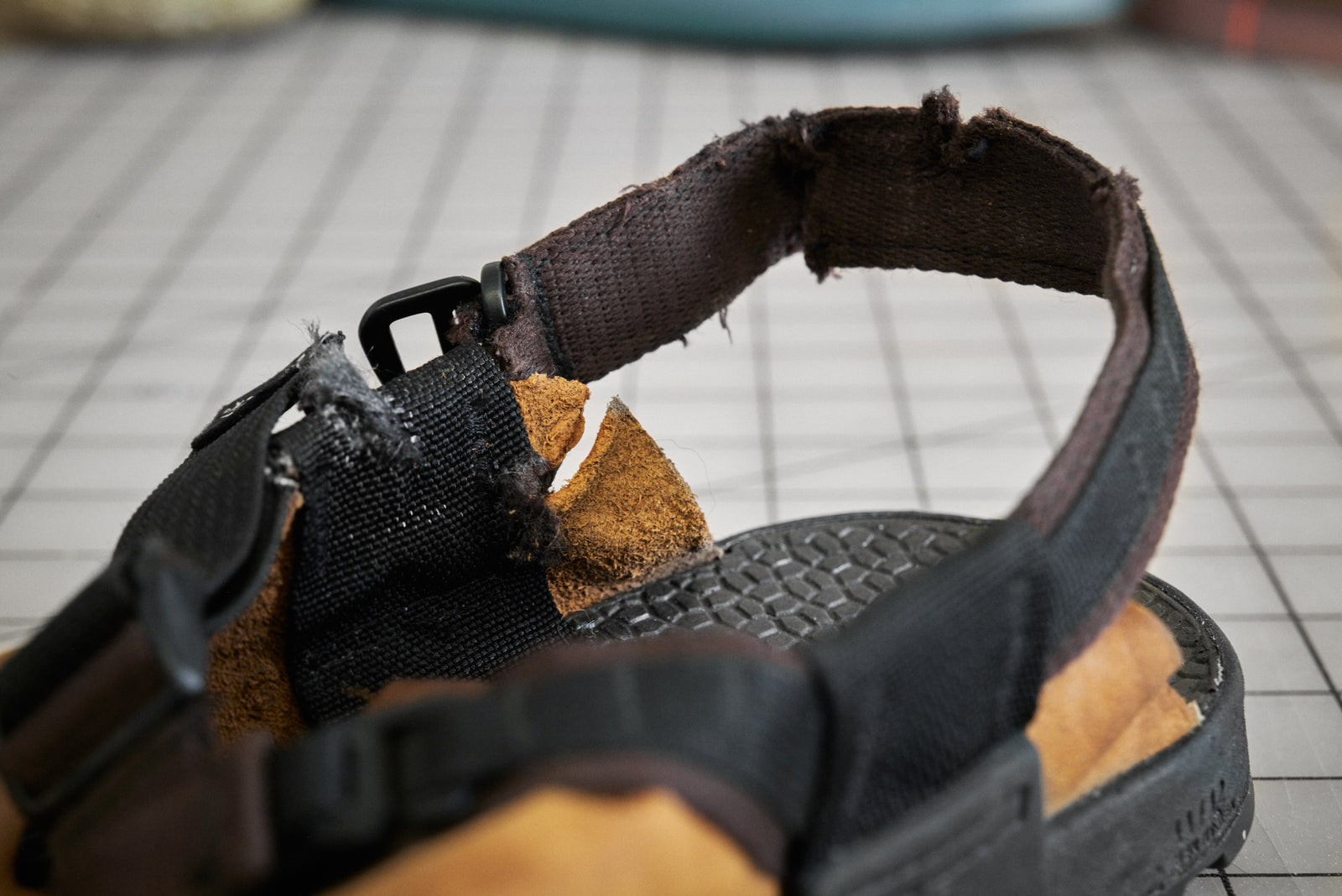 Close up of a clog shoe with torn straps